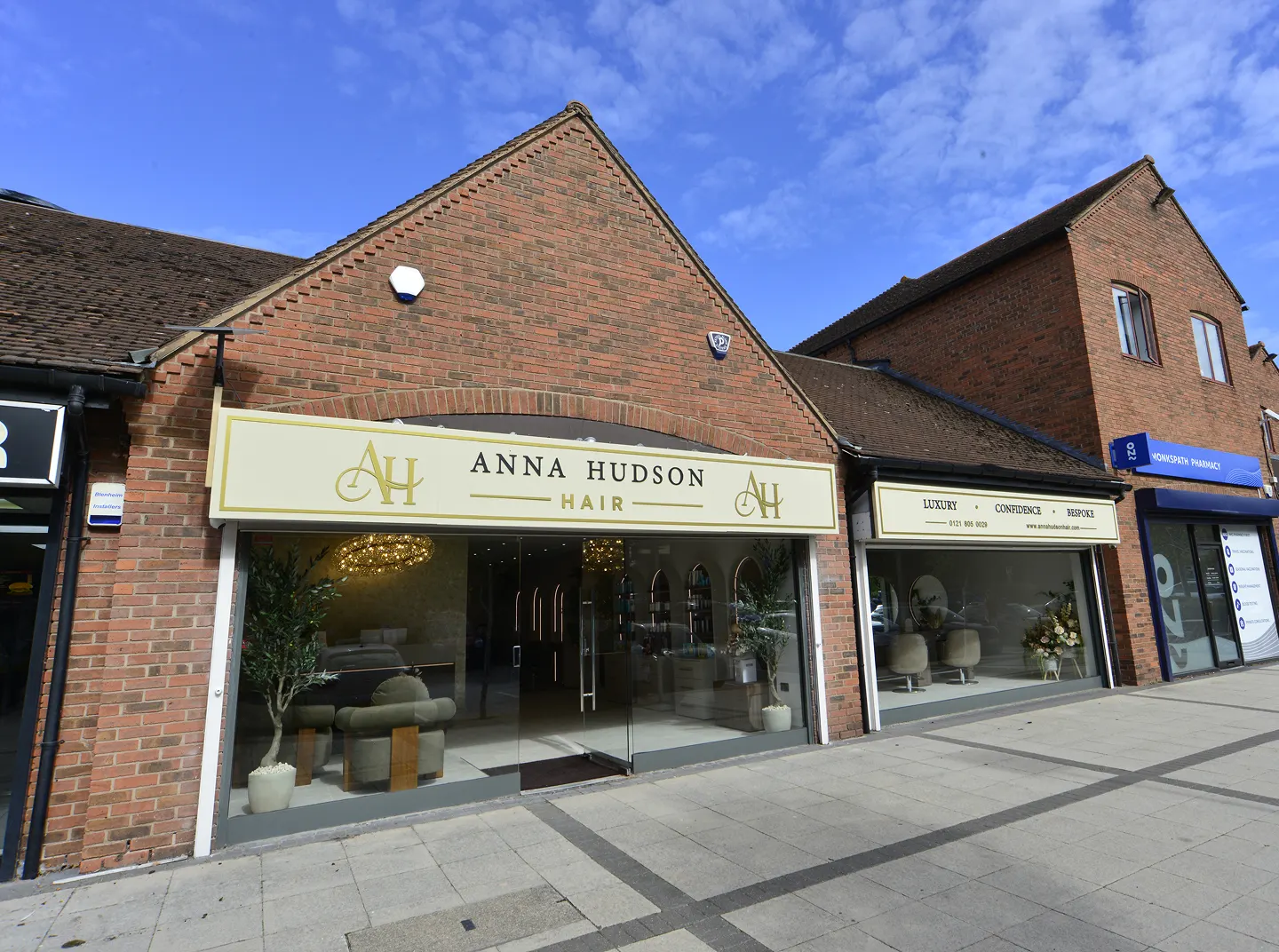 Anna Hudson Hair in Stoke-on-Trent, is a building with glass walls and doors, and a name board